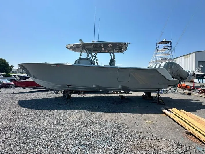 Fortuna Yacht Photos Pics 2021 SeaVee 370z boat on dry dock, side view, clear sky background.