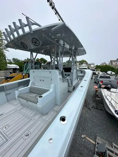 Fortuna Yacht Photos Pics 2021 SeaVee 370z boat with spacious deck and seating, parked outdoors.