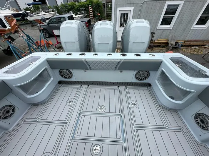 Fortuna Yacht Photos Pics 2021 SeaVee 370z boat deck with triple outboard engines and spacious storage compartments.