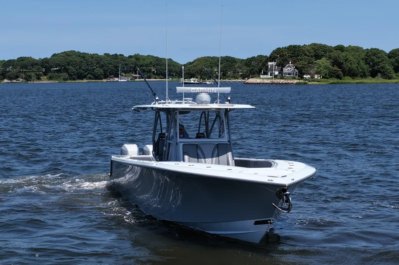 Fortuna Yacht Photos Pics 2021 SeaVee 370z boat cruising on a calm lake with lush green shoreline.