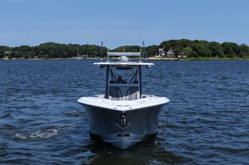 Fortuna Yacht Photos Pics 2021 SeaVee 370z boat cruising on a calm lake with a scenic shoreline.