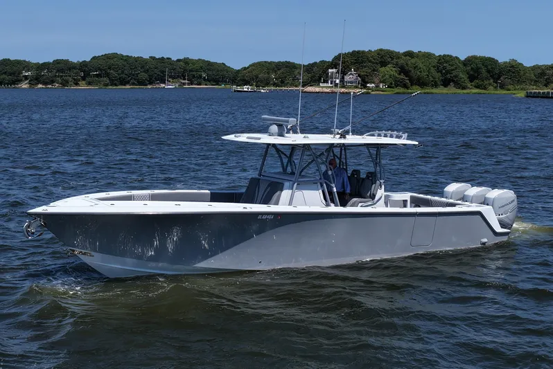 Fortuna Yacht Photos Pics 2021 SeaVee 370z boat cruising on a lake with lush green shoreline.