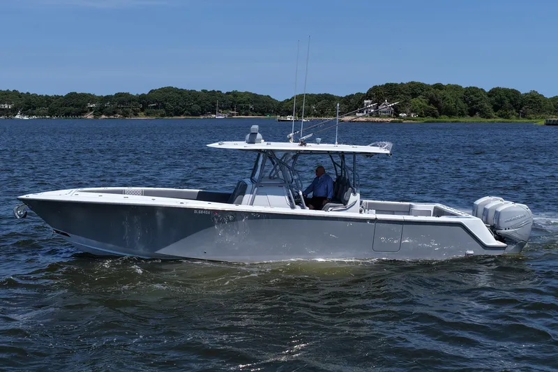 Fortuna Yacht Photos Pics 2021 SeaVee 370z boat cruising on a calm lake with lush green shoreline.