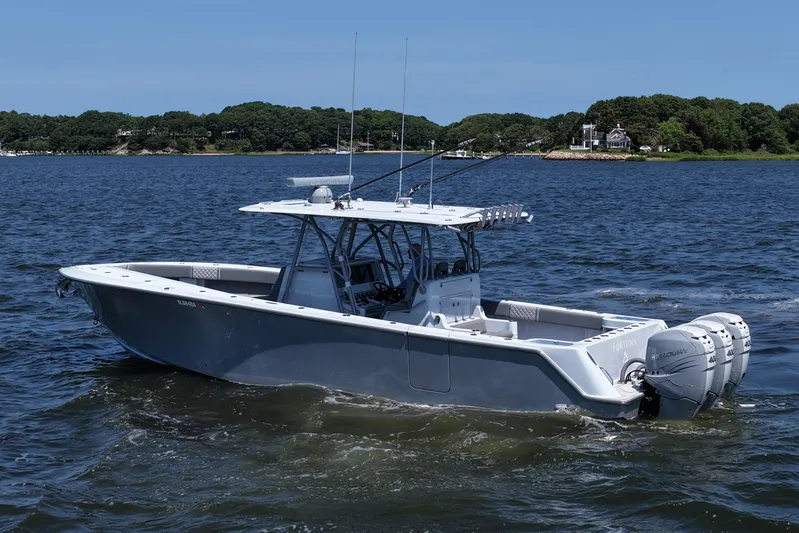 Fortuna Yacht Photos Pics 2021 SeaVee 370z boat on water with triple Mercury engines, scenic background.