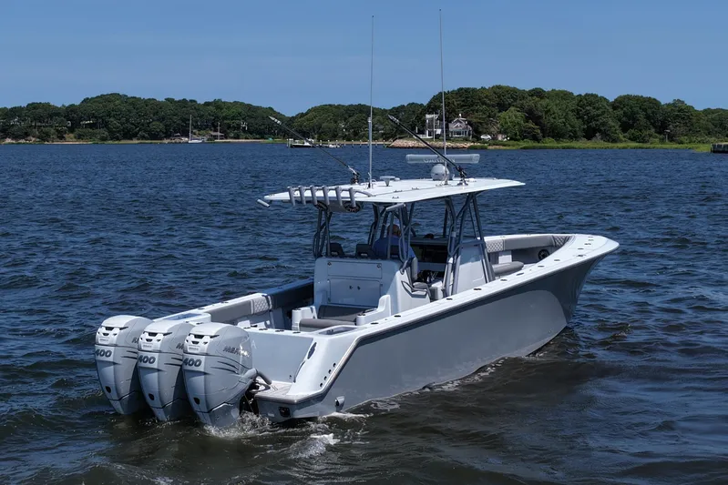 Fortuna Yacht Photos Pics 2021 SeaVee 370z boat with triple outboard engines on a calm lake.
