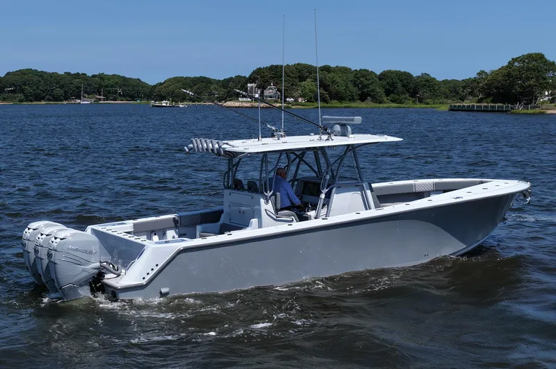 Fortuna Yacht Photos Pics 2021 SeaVee 370z boat cruising on a calm lake with scenic background.
