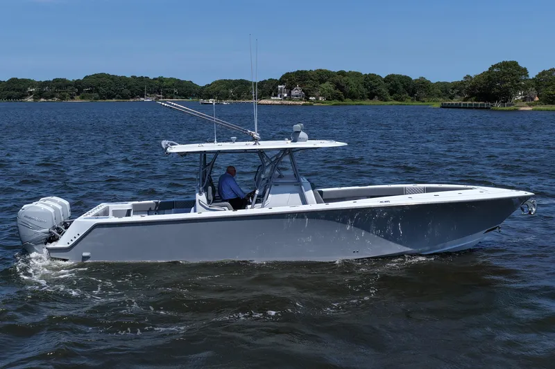 Fortuna Yacht Photos Pics 2021 SeaVee 370z boat cruising on a calm lake with scenic shoreline.