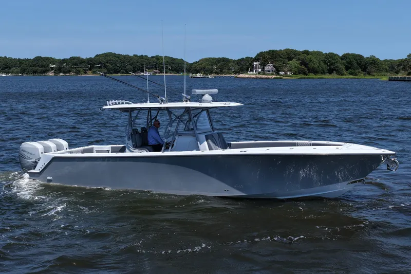Fortuna Yacht Photos Pics 2021 SeaVee 370z boat cruising on a calm lake with lush green shoreline.