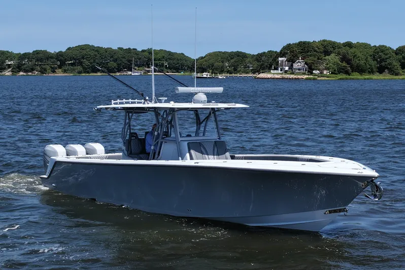 Fortuna Yacht Photos Pics 2021 SeaVee 370z boat cruising on a calm lake with scenic shoreline.