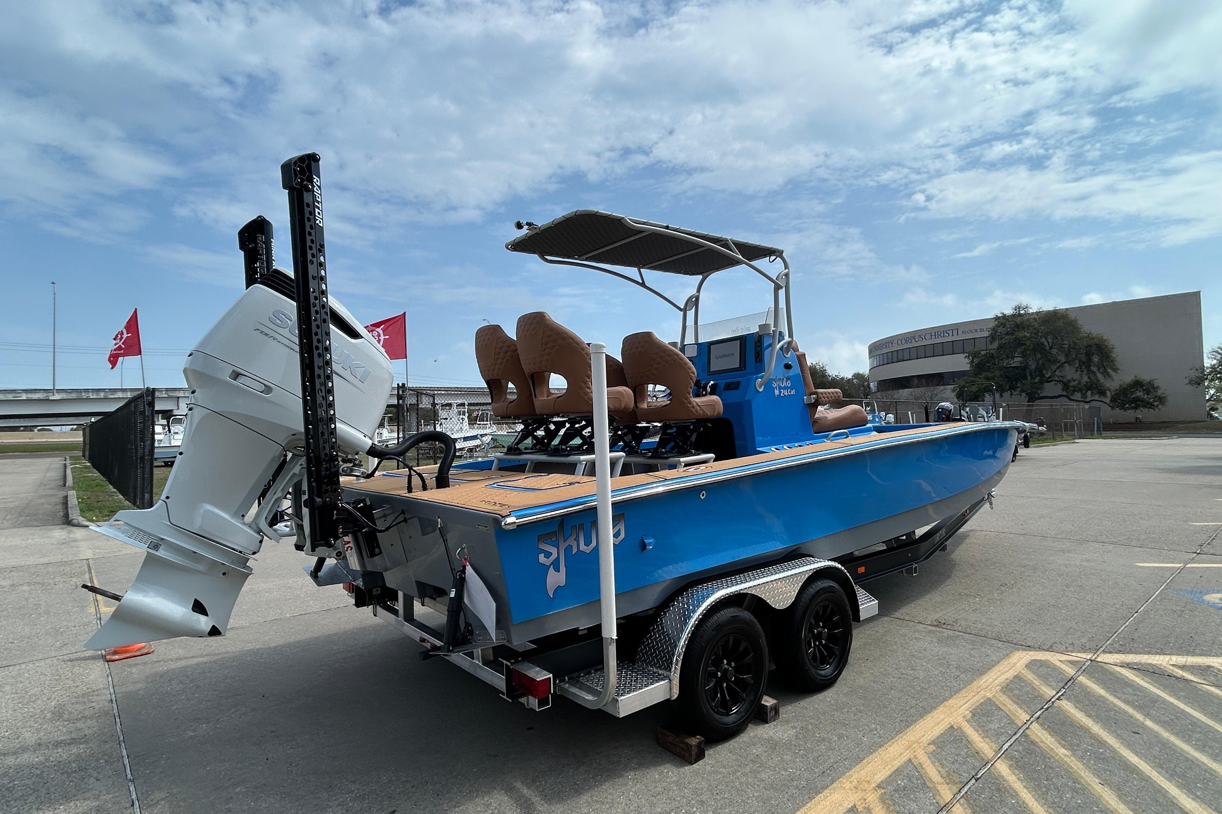 2026 Skuta 24 Skuta Cat boat on trailer, blue exterior, parked outdoors.
