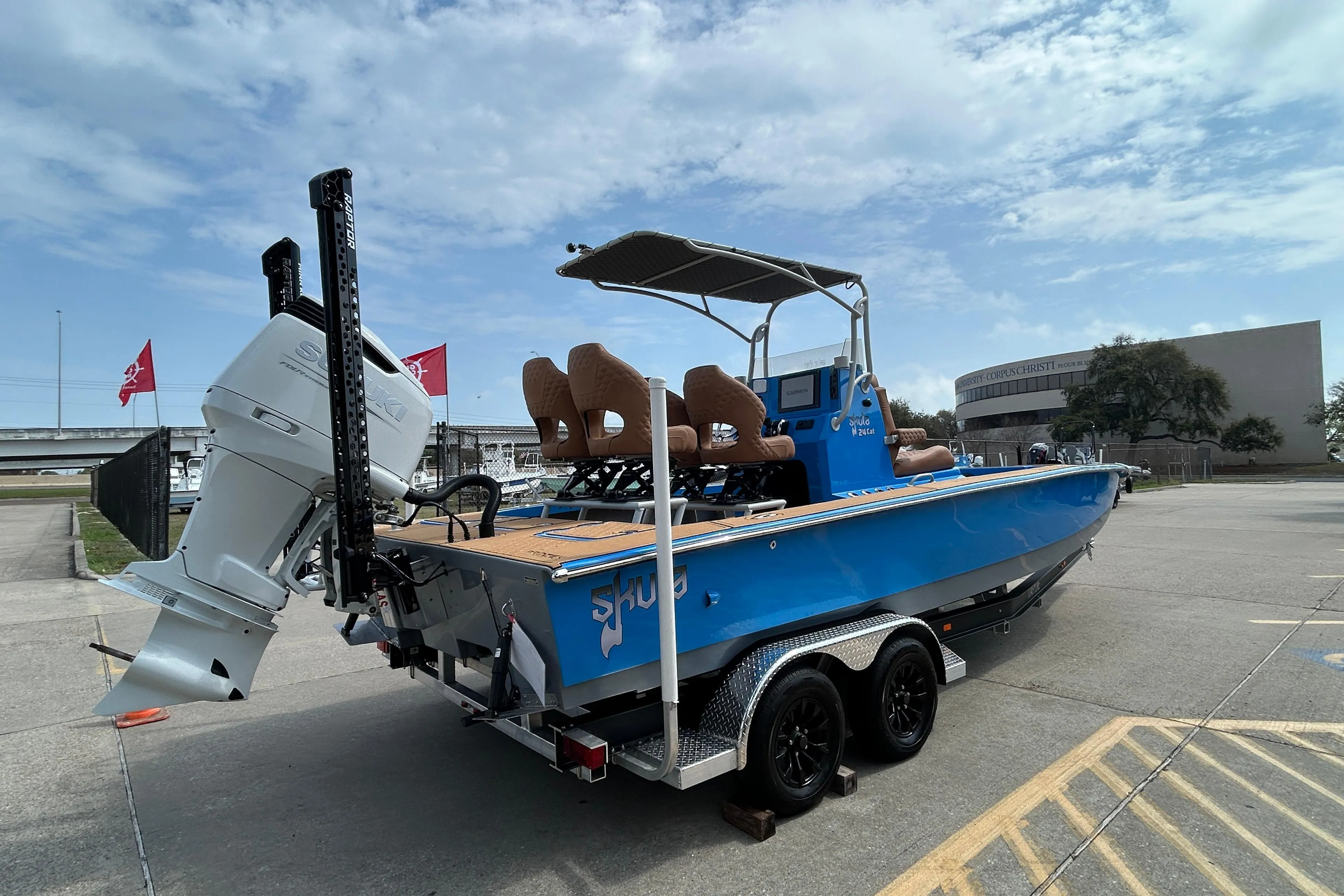 2026 Skuta 24 Skuta Cat boat on trailer, blue exterior, parked outdoors.