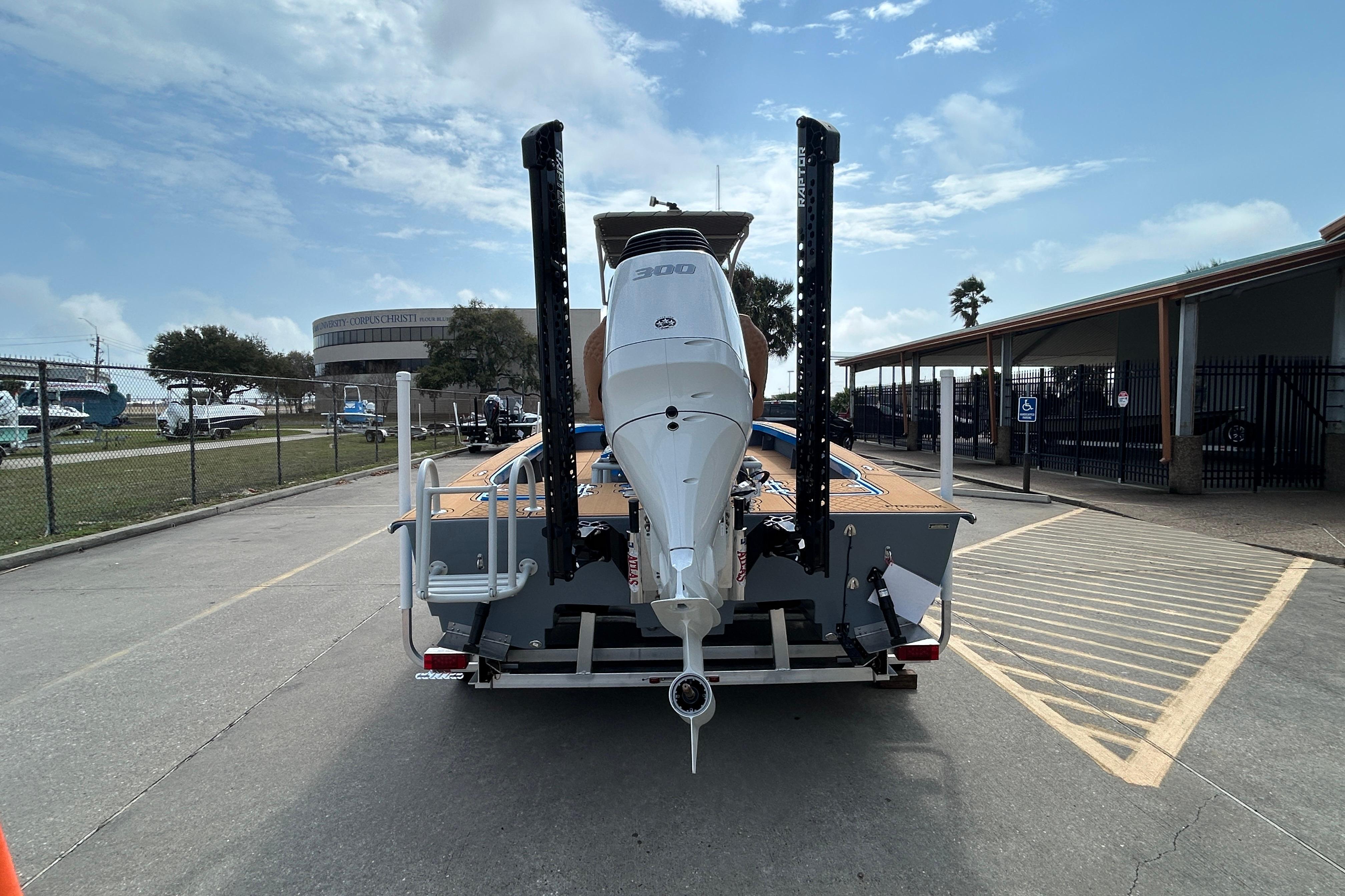 2026 Skuta 24 Skuta Cat boat with powerful outboard motor on trailer.