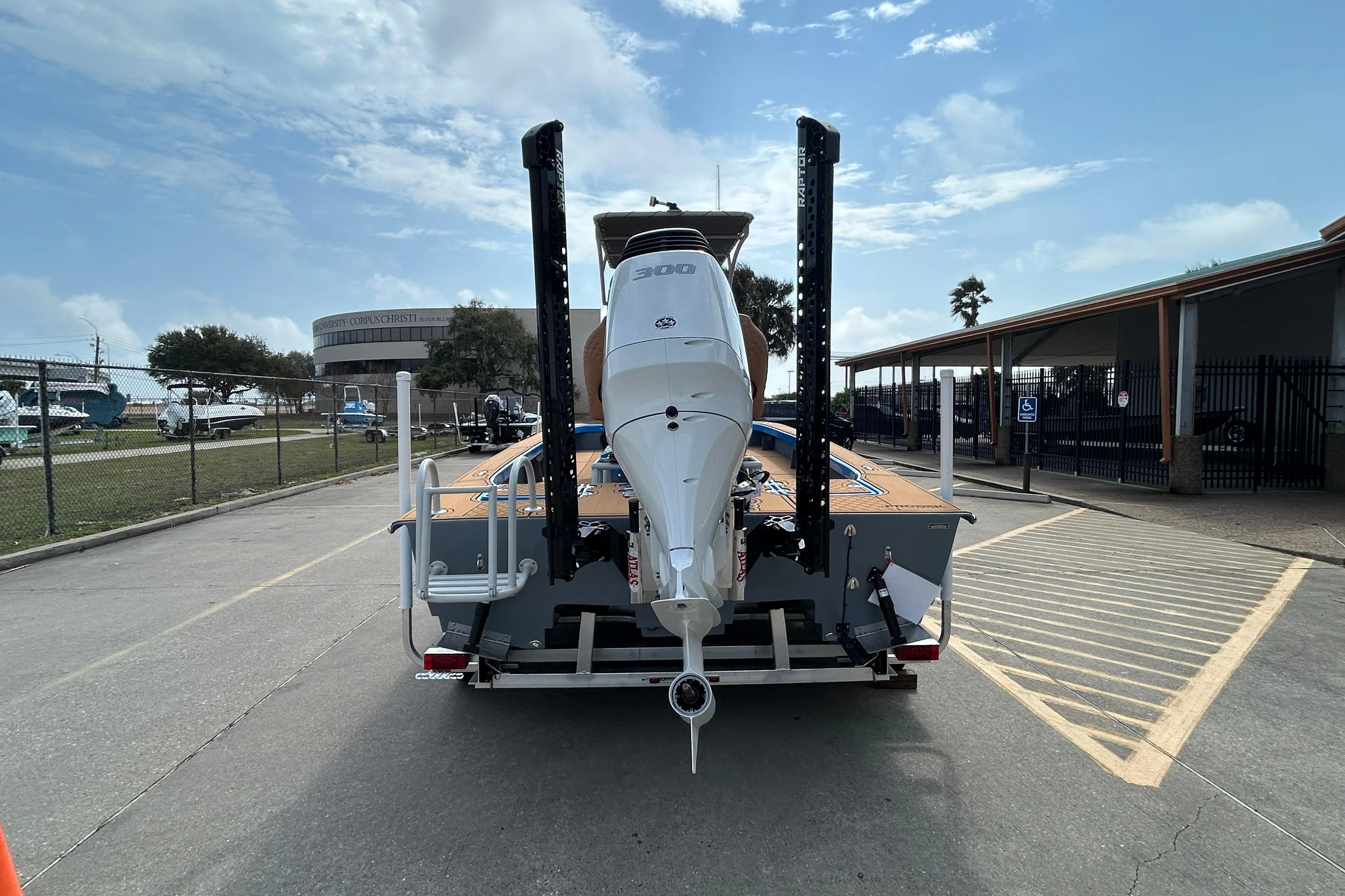 2026 Skuta 24 Skuta Cat boat with powerful outboard motor on trailer.