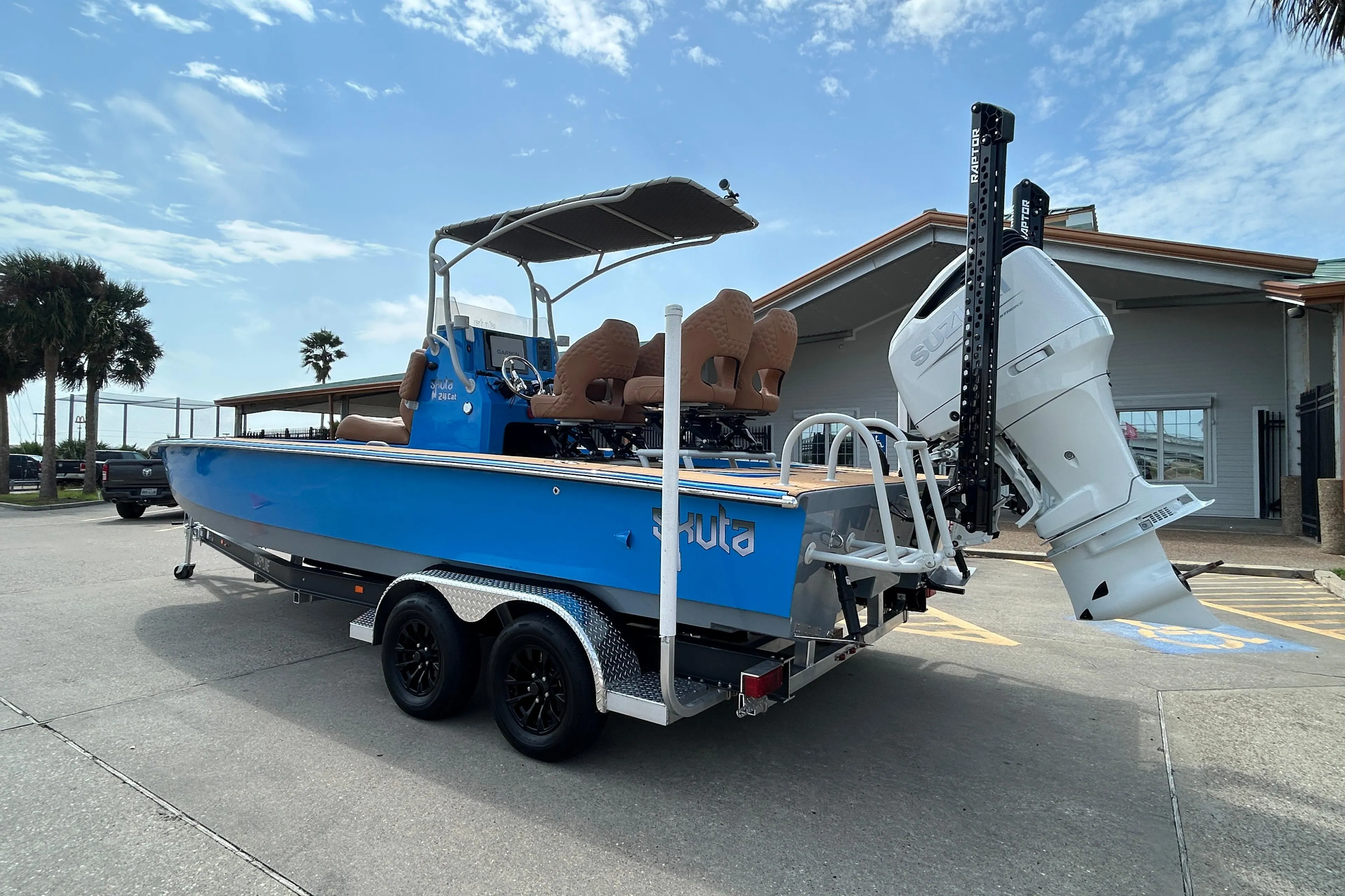 2026 Skuta 24 Skuta Cat boat on trailer, blue exterior, parked outdoors.
