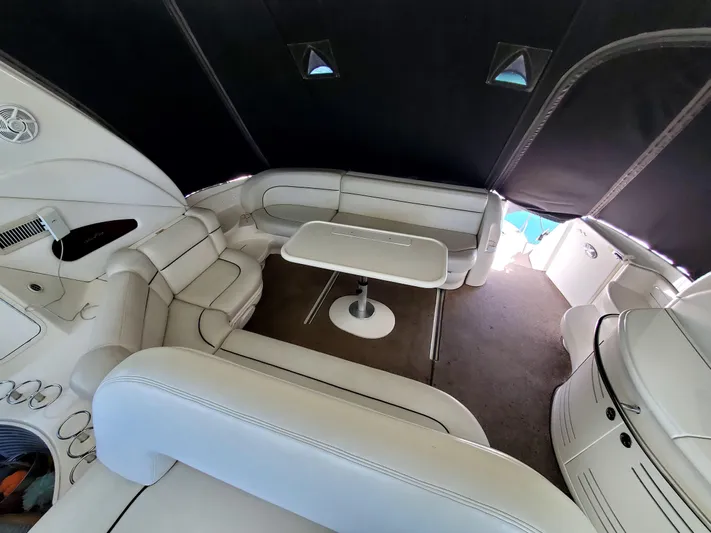 Sunbear Express Yacht Photos Pics Interior of 2001 Sea Ray 510 Sundancer yacht with white seating and table.
