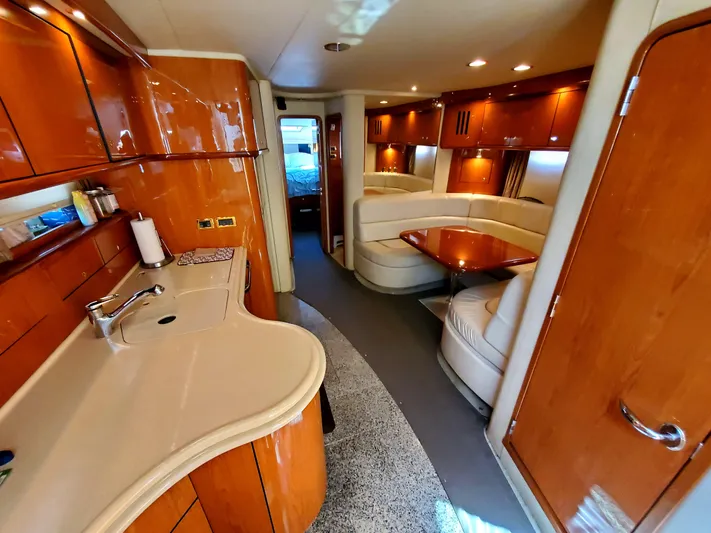 Sunbear Express Yacht Photos Pics Luxurious interior of 2001 Sea Ray 510 Sundancer yacht with elegant wood finishes.