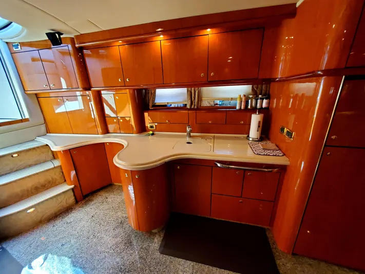 Sunbear Express Yacht Photos Pics Luxurious kitchen interior of 2001 Sea Ray 510 Sundancer yacht with wooden cabinetry.