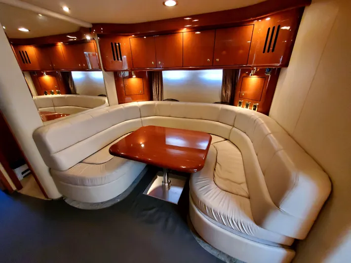 Sunbear Express Yacht Photos Pics Luxurious interior of 2001 Sea Ray 510 Sundancer yacht with plush seating and wooden table.
