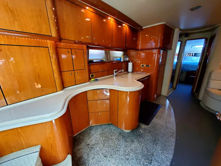 Sunbear Express Yacht Photos Pics Luxurious interior of 2001 Sea Ray 510 Sundancer yacht with sleek wooden cabinetry.