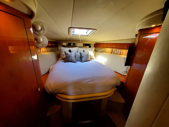 Sunbear Express Yacht Photos Pics Luxurious cabin interior of 2001 Sea Ray 510 Sundancer yacht with cozy bed and elegant decor.