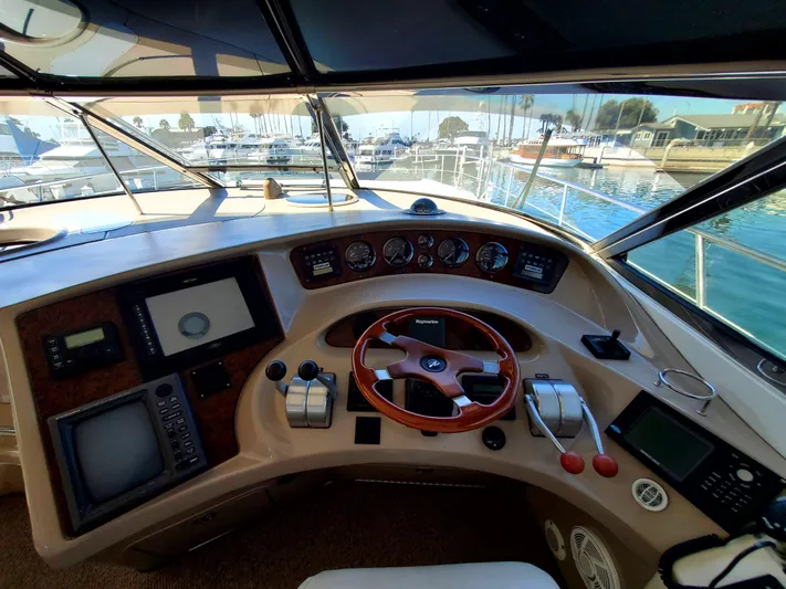 Sunbear Express Yacht Photos Pics Helm of 2001 Sea Ray 510 Sundancer yacht with navigation instruments and steering wheel.