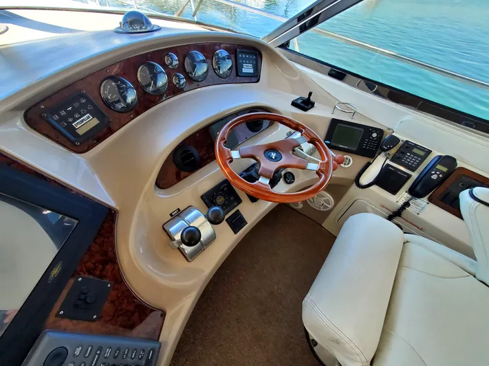 Sunbear Express Yacht Photos Pics 2001 Sea Ray 510 Sundancer helm with wood accents and modern navigation instruments.