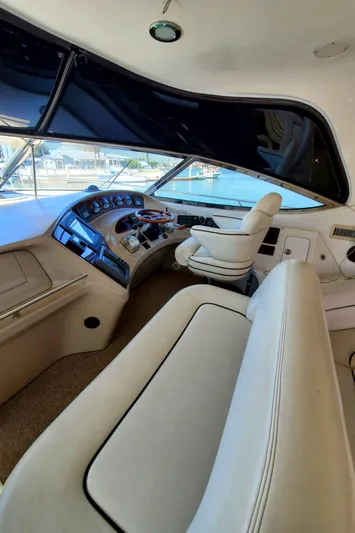 Sunbear Express Yacht Photos Pics Interior view of 2001 Sea Ray 510 Sundancer yacht cockpit with leather seating and control panel.