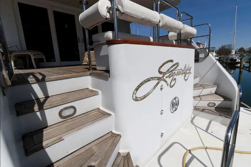 Liquidity Yacht Photos Pics 1984 Broward Raised Pilothouse yacht with wooden steps and elegant design details.