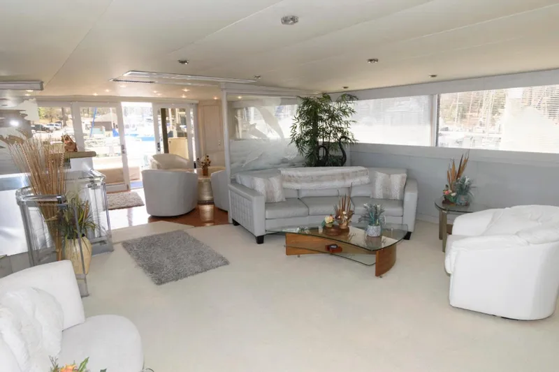 Liquidity Yacht Photos Pics Luxurious interior of 1984 Broward Raised Pilothouse yacht with elegant seating and decor.