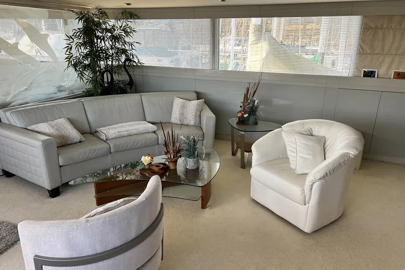 Liquidity Yacht Photos Pics Luxurious 1984 Broward Raised Pilothouse yacht interior with elegant seating and decor.