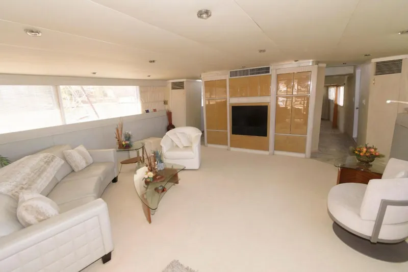 Liquidity Yacht Photos Pics Luxurious interior of 1984 Broward Raised Pilothouse yacht with elegant seating and decor.