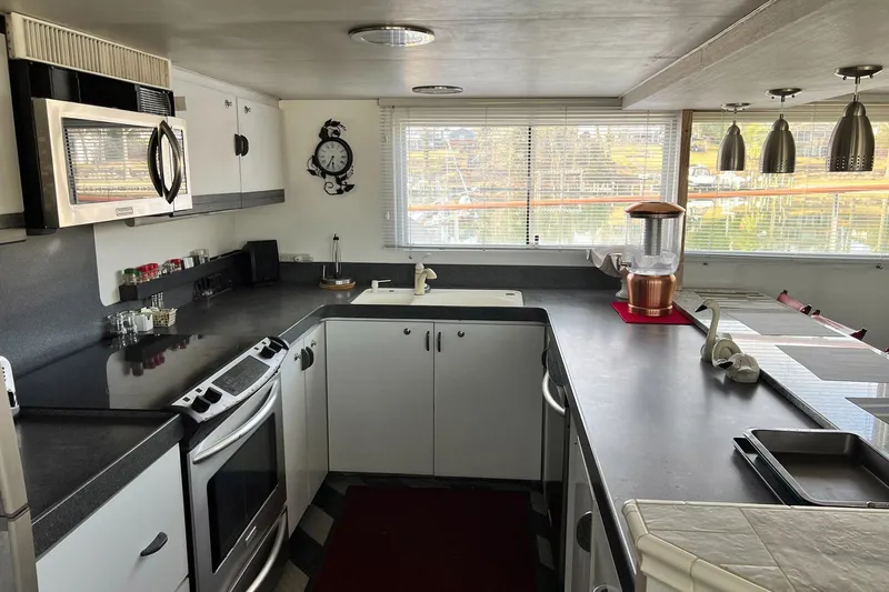 Liquidity Yacht Photos Pics 1984 Broward Raised Pilothouse kitchen with modern appliances and ample counter space.