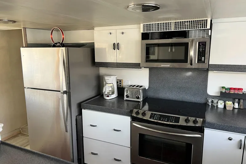 Liquidity Yacht Photos Pics Modern kitchen in 1984 Broward Raised Pilothouse yacht with stainless steel appliances.
