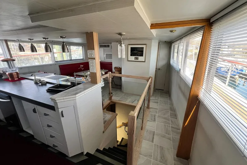 Liquidity Yacht Photos Pics Interior of 1984 Broward Raised Pilothouse yacht with modern kitchen and staircase.