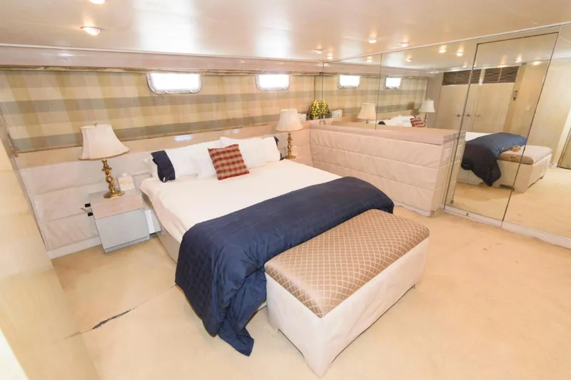 Liquidity Yacht Photos Pics Luxurious bedroom interior on 1984 Broward Raised Pilothouse yacht with elegant decor.