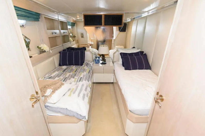 Liquidity Yacht Photos Pics Luxurious twin cabin interior of 1984 Broward Raised Pilothouse yacht with elegant decor.