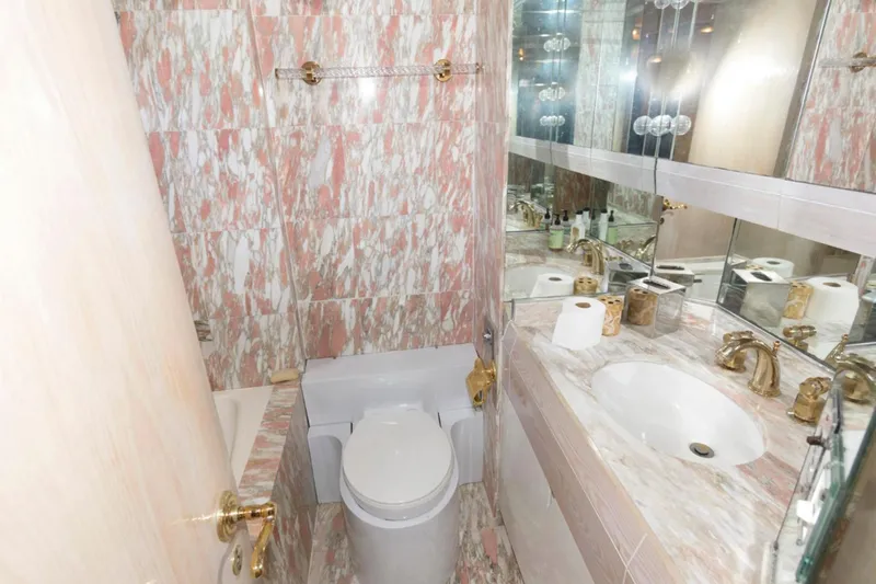 Liquidity Yacht Photos Pics Luxurious bathroom with marble decor in 1984 Broward Raised Pilothouse yacht.