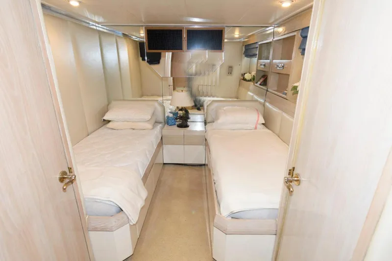 Liquidity Yacht Photos Pics Luxurious twin cabin interior of 1984 Broward Raised Pilothouse yacht with elegant decor.