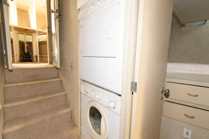Liquidity Yacht Photos Pics Laundry area with stacked washer and dryer in 1984 Broward Raised Pilothouse yacht.