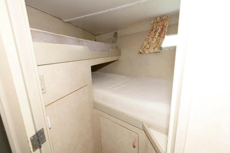Liquidity Yacht Photos Pics Compact cabin with bunk beds in 1984 Broward Raised Pilothouse yacht.