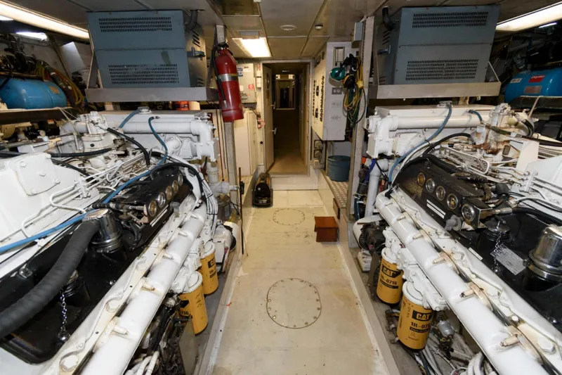 Liquidity Yacht Photos Pics Engine room of 1984 Broward Raised Pilothouse yacht, featuring dual engines and equipment.