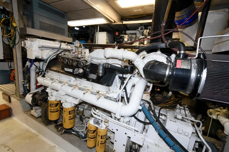 Liquidity Yacht Photos Pics Engine room of 1984 Broward Raised Pilothouse yacht, featuring detailed machinery and components.