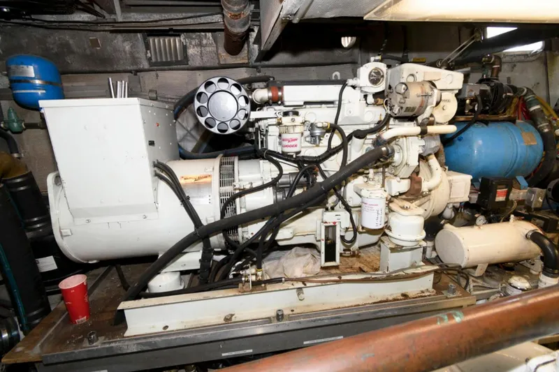 Liquidity Yacht Photos Pics Engine room of 1984 Broward Raised Pilothouse yacht, featuring machinery and equipment.