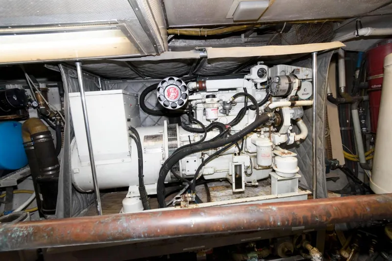 Liquidity Yacht Photos Pics Engine room of 1984 Broward Raised Pilothouse yacht, showcasing machinery and equipment.