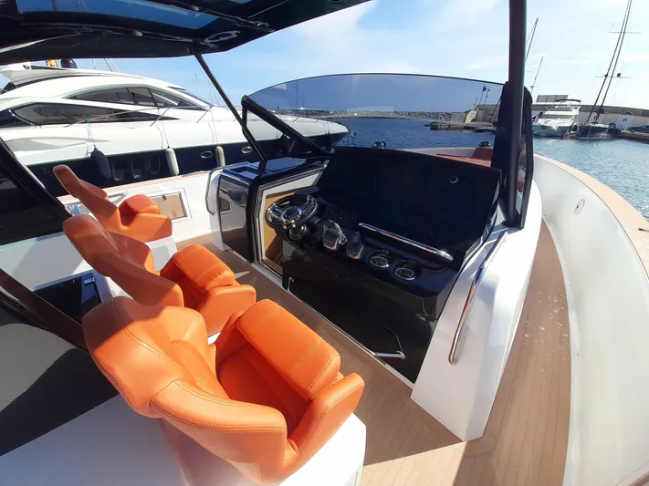  Yacht Photos Pics 2023 Pardo Yachts 50 helm with orange seats, docked in a marina.