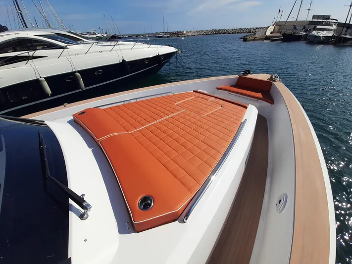  Yacht Photos Pics 2023 Pardo Yachts 50 with orange deck cushions, docked in a marina.