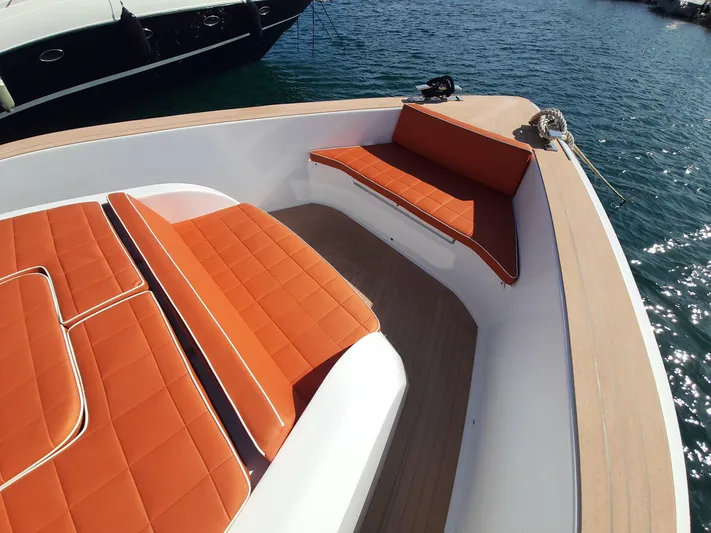  Yacht Photos Pics Luxurious 2023 Pardo Yachts 50 with orange seating, docked on calm waters.