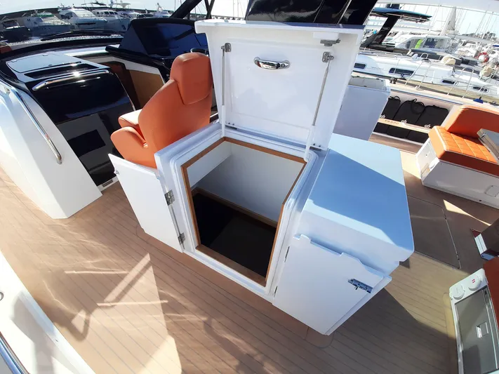  Yacht Photos Pics 2023 Pardo Yachts 50 interior with open storage compartment and orange seating.