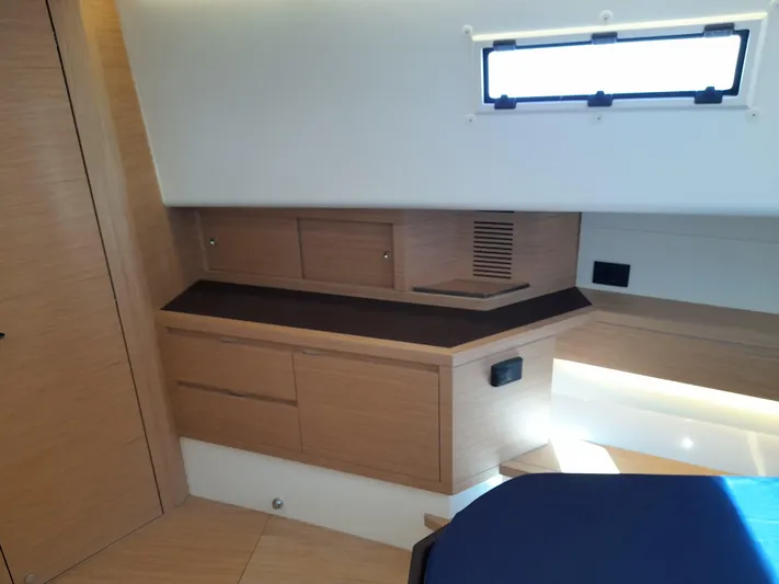  Yacht Photos Pics 2023 Pardo Yachts 50 interior cabin with modern wood cabinetry and window.