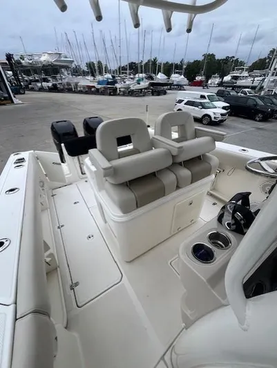  Yacht Photos Pics 2020 Boston Whaler 280 Outrage boat interior with seating and marina view.